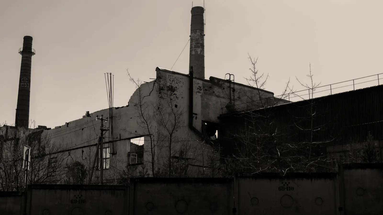 An abandoned factory hall with chimneys